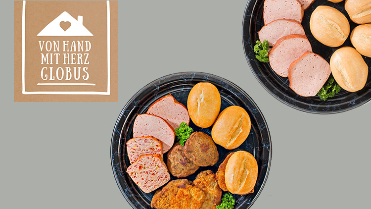 Zwei schwarze Platten mit Brötchen, Frikadellen, Schnitzeln und Leberkäse, daneben der Text VON HAND MIT HERZ GLOBUS.